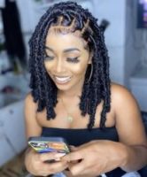 Woman with braided hairstyle using smartphone, black hair styles, #tik4tat